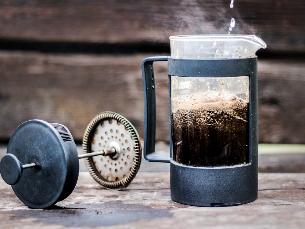 A French press brewing fresh coffee