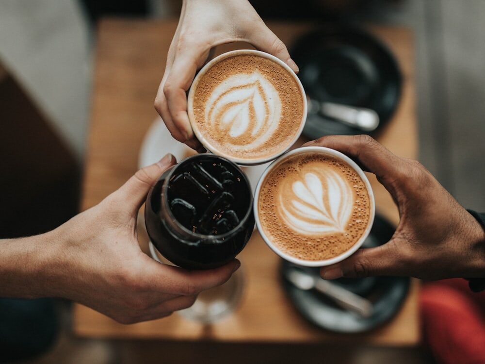 Two friends toasting coffee cups